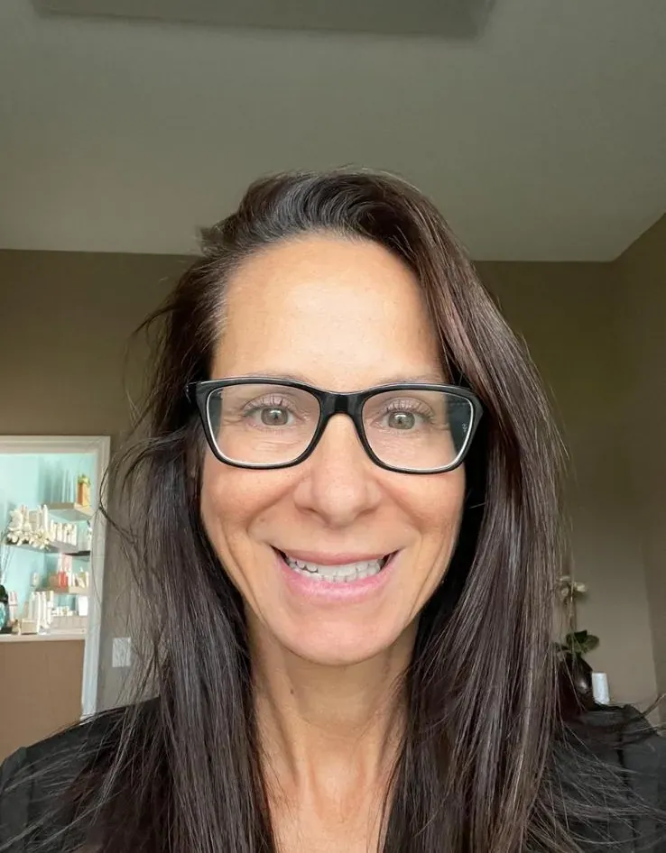 Tami, licensed esthetician and owner of Face & Lash Studio, smiling in her Port Orange studio